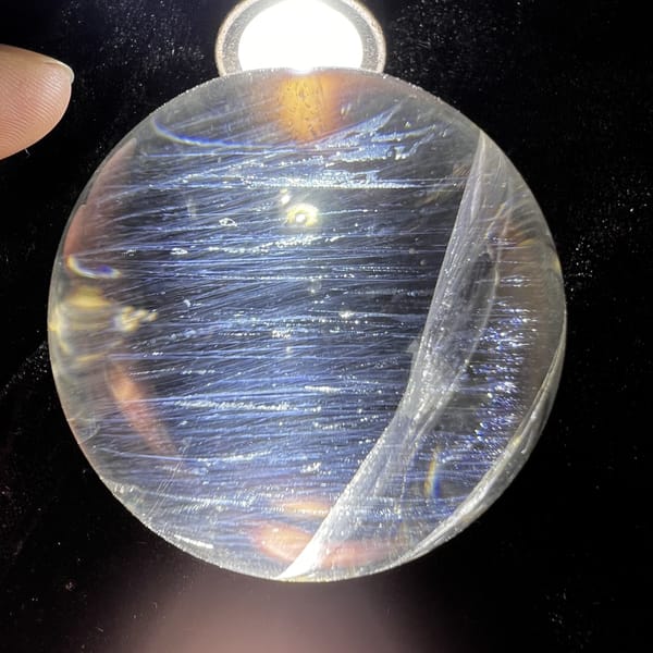 Torchlit sphere with horizontal blue needles and a curved plane