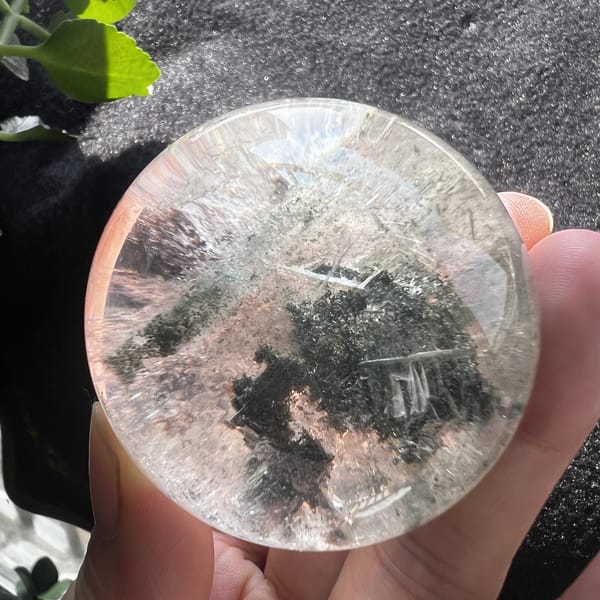 Green phantom quartz sphere with the mound offset to one side