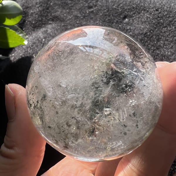 Green phantom sphere with misty white veils and pale green speckles