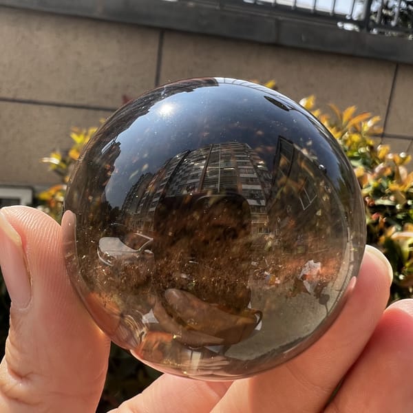 Smoky sphere with warm brown clouds and a faint rainbow