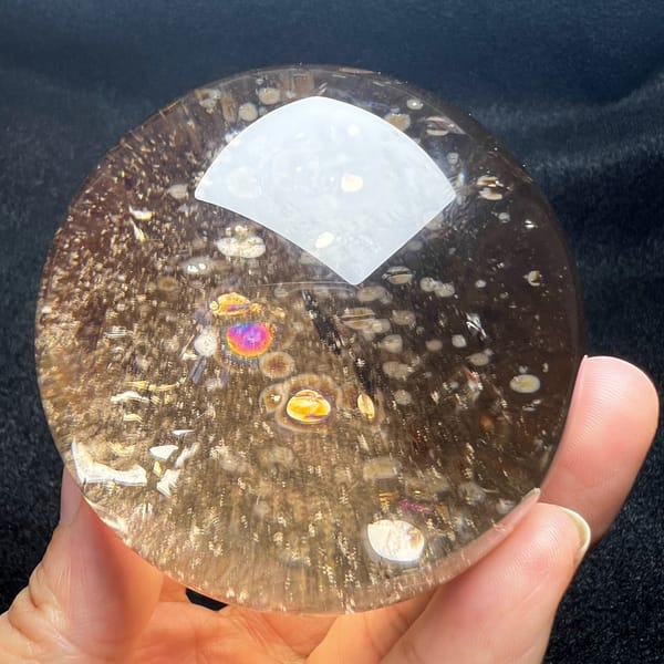 Smoky sphere with a vivid rainbow among tiny disc inclusions