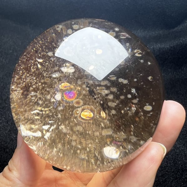 Smoky sphere with violet and gold rainbow flashes