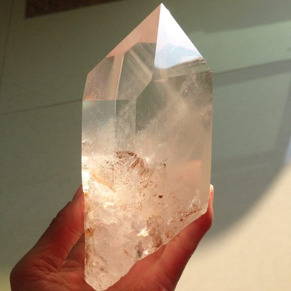 Point standing upright with a clear tip and cloudy, rust-flecked base