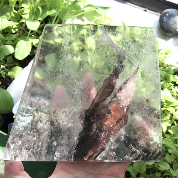 Freeform held outdoors over plants, sunlight passing through the phantom