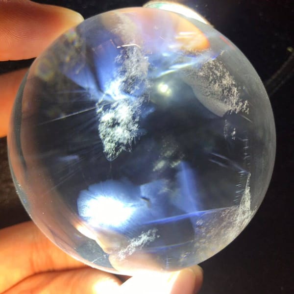 Ink-blue needle zone and a white snowflake cluster near the sphere's centre