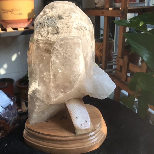 Front view of the crystal on its display base in warm evening light