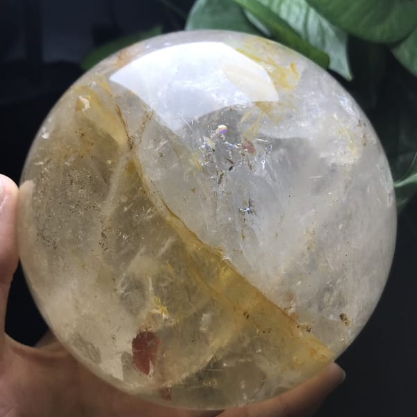 Sphere turned to show a diagonal yellow plane and a small red flake