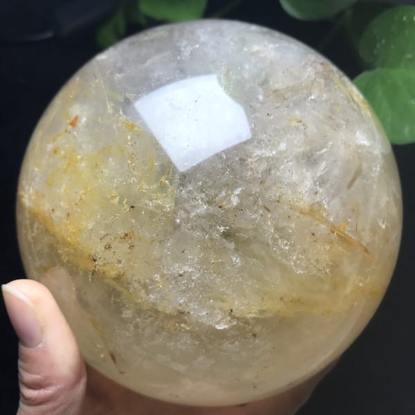 Side view with scattered golden inclusions and clear crystal