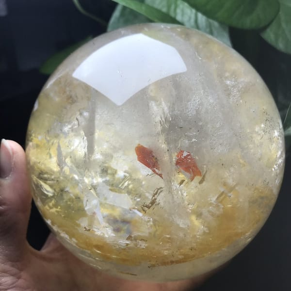 Red flakes and golden layer seen from slightly above the sphere