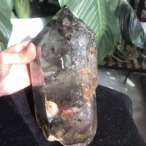 Point held at the side showing translucent body and white base inclusions