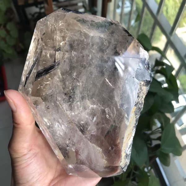 Front of the piece in hand with tourmaline at the top right corner