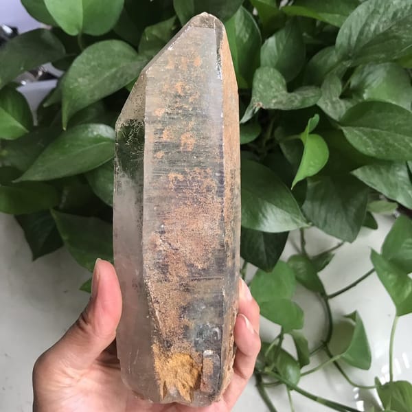 Rust-speckled phantom face and iron-stained base in daylight