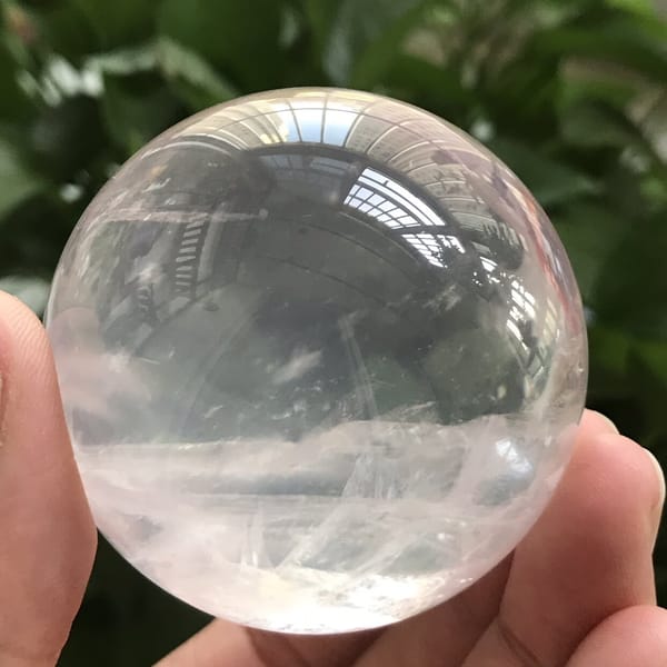 Fine white streaks crossing the lower half of the transparent sphere