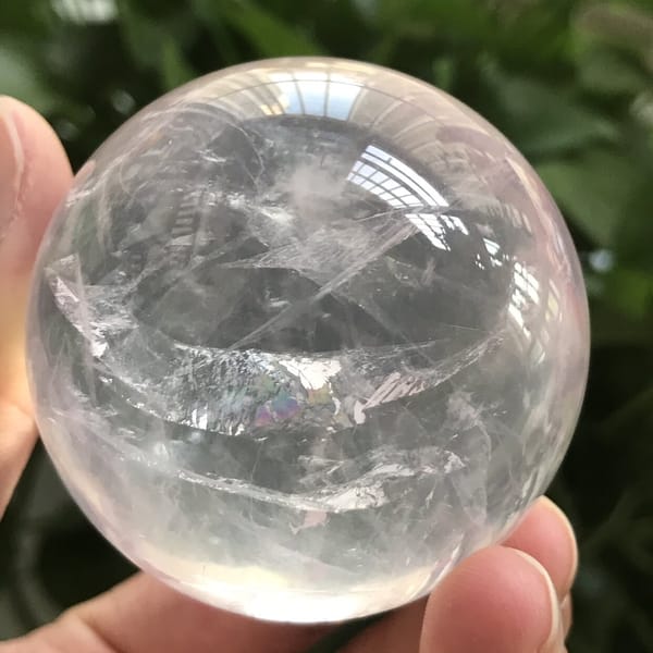 Rainbow glint within the white inclusion band of the rose quartz