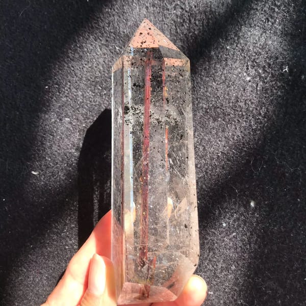 Front view of the point with copper rutile and dark green specks