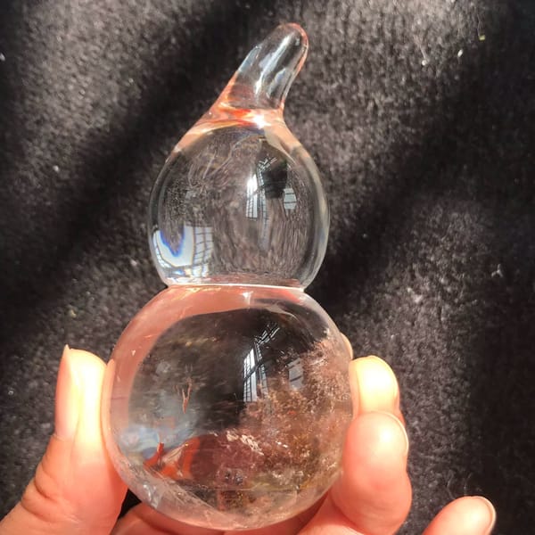 Gourd held upright with curled stem and red inclusions at the bottom