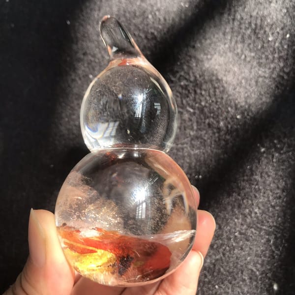 Front view of the clear gourd with a golden layer in its base