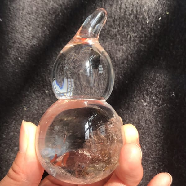 Gourd in hand with misty inclusions in the lower bulb