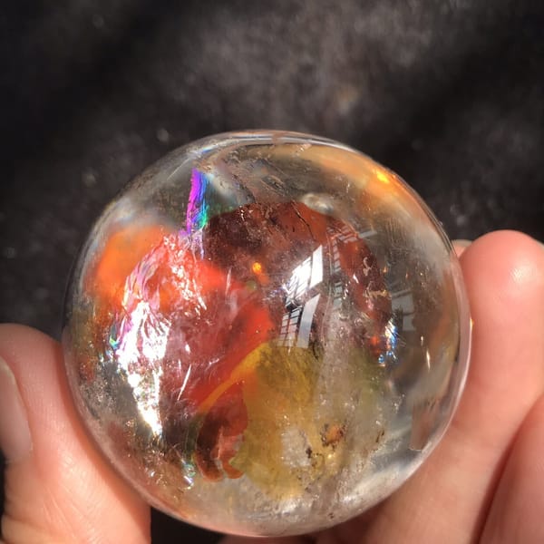 Underside of the gourd with red and amber clouds and a rainbow