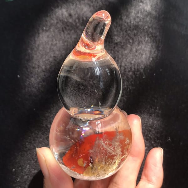 Bright red inclusion in the base of the polished quartz gourd