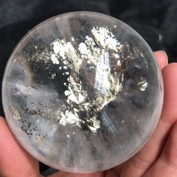 Clear quartz sphere with a glittering metallic chalcopyrite tree at its centre