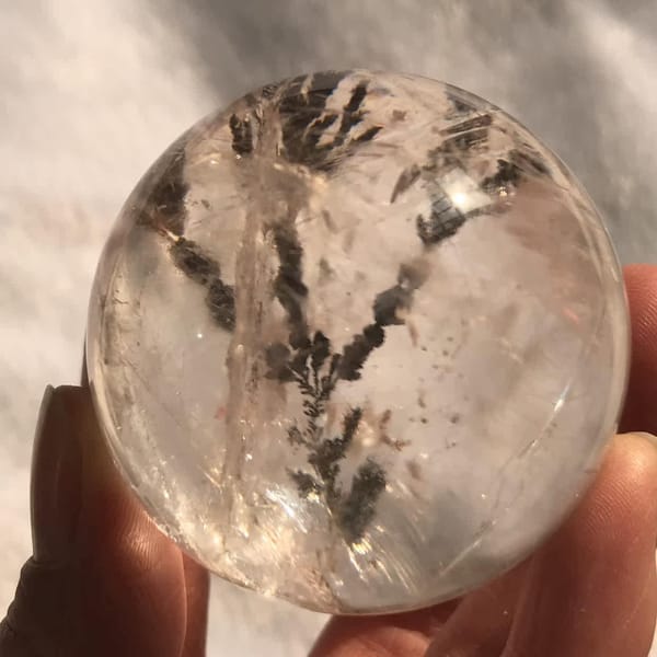 Tree inclusion and white wisps seen from a different side of the sphere