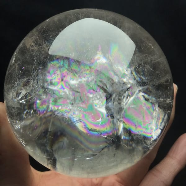 Rainbow cluster under the light reflection of the polished sphere