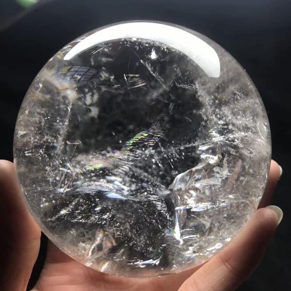 Clearer back side of the sphere with white veils and a soft rainbow