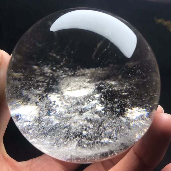 Misty smoke-like cloud centred in the clear quartz ball