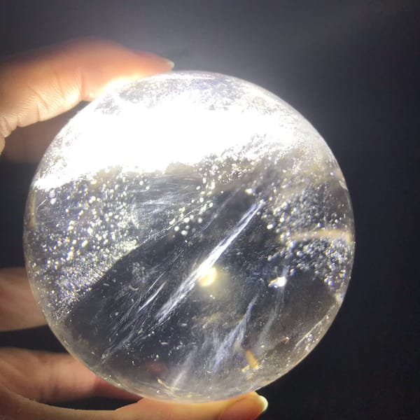 Backlit sphere showing glittering specks and a bright streak