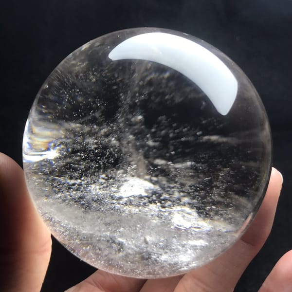Clear sphere with misty streaks and a frosted patch at the base