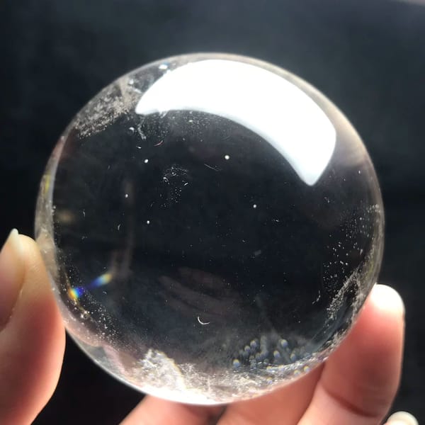 Clear quartz ball with a frosted patch near the bottom edge