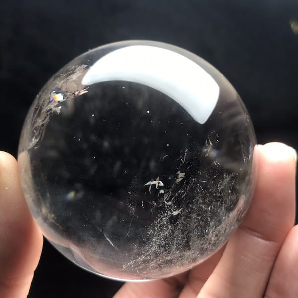 Fine white wisps in the lower right of the clear sphere