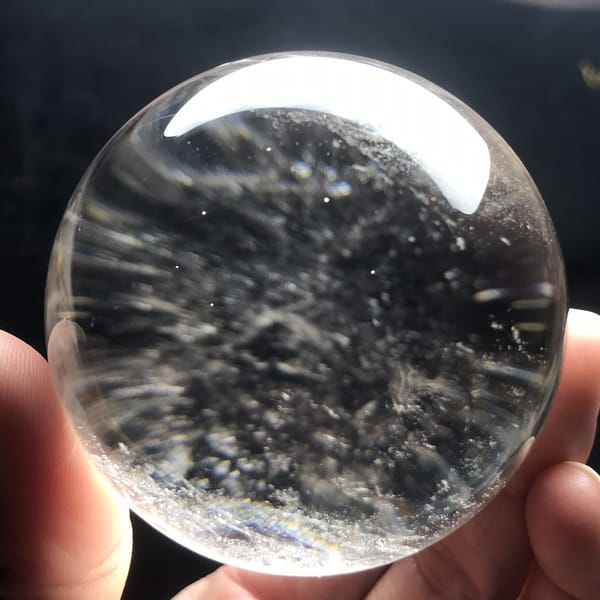 Reflected light lines and pale haze across the sphere