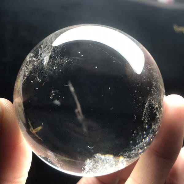 Clear sphere showing a slim white streak and frosted lower edge