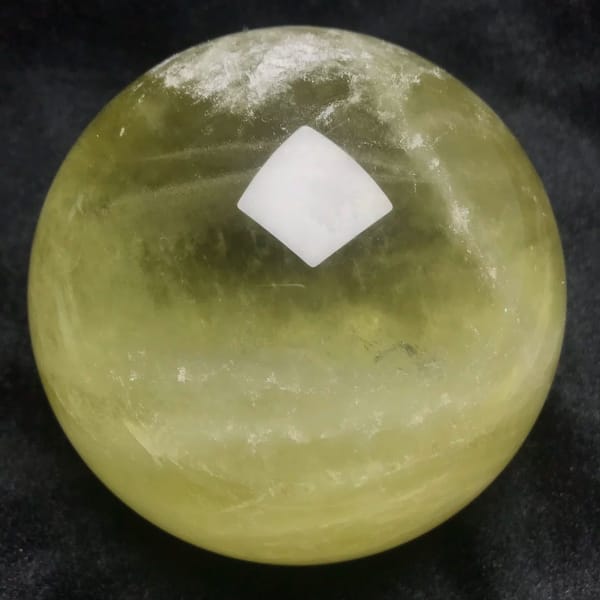 Deeper yellow and greenish tones in the lower half of the sphere