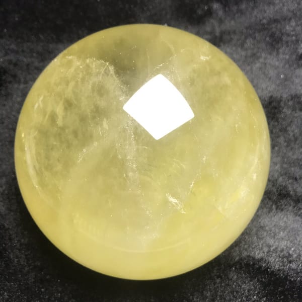 Fine white streaks across the centre of the big sphere
