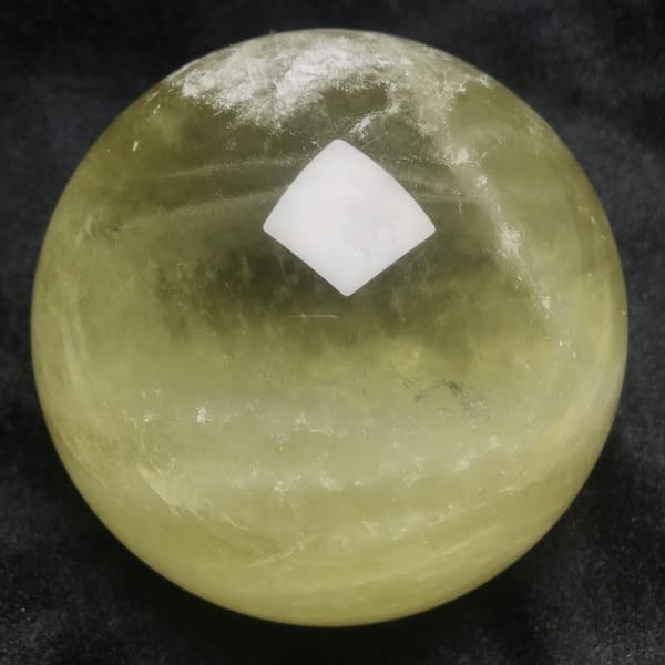Citrine sphere with white veils near the top and darker centre