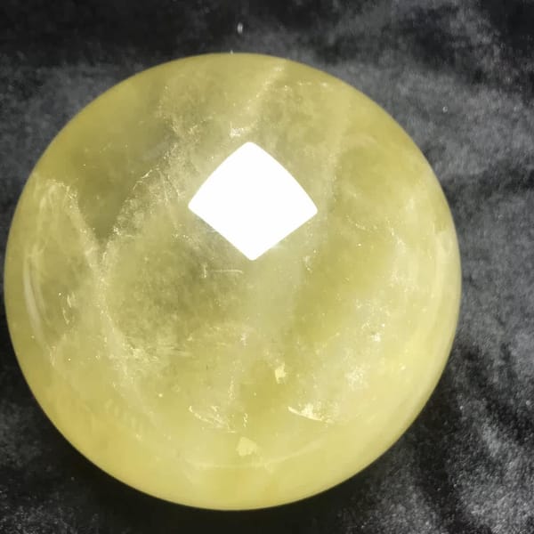 Feathery veils on the left side of the bright yellow sphere