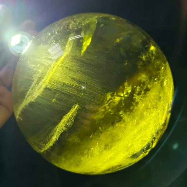 Strong backlight revealing silky streaks inside the yellow sphere