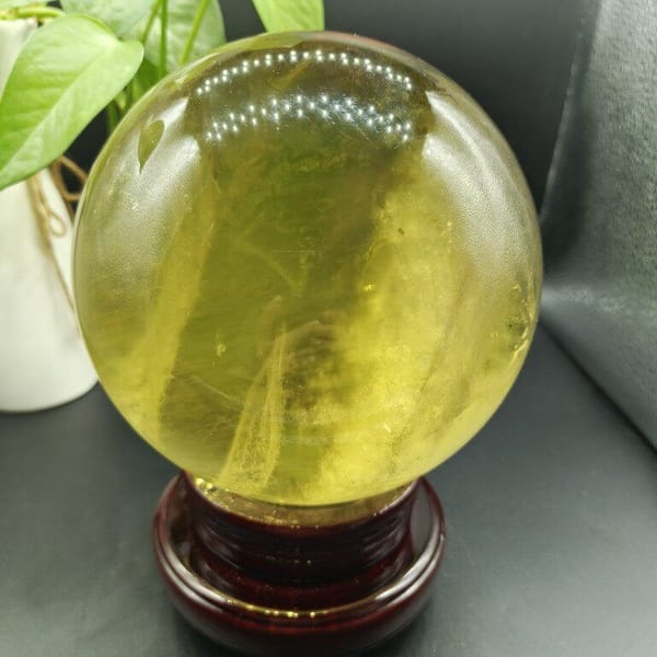 Large citrine on its stand with fine streaks and clear areas