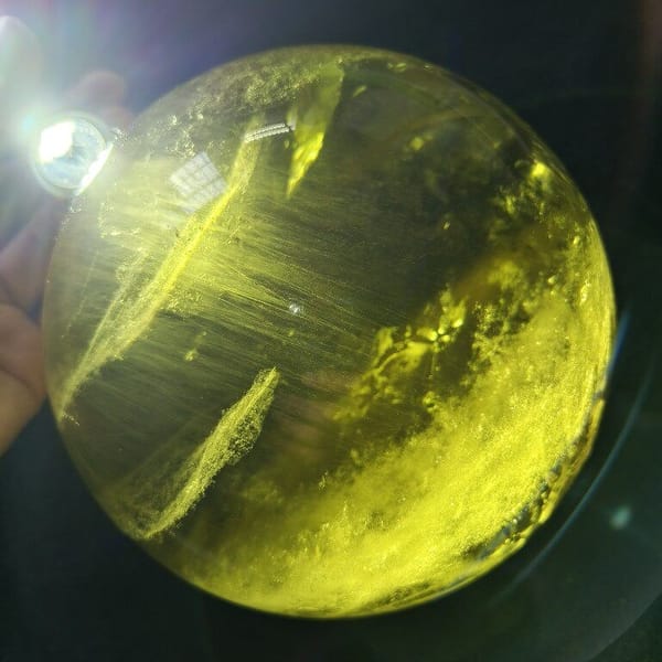 Close backlit view of dense smoke-like streaks in the citrine