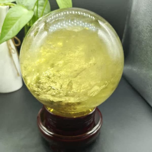 Frosted layered inclusions near the base of the citrine sphere