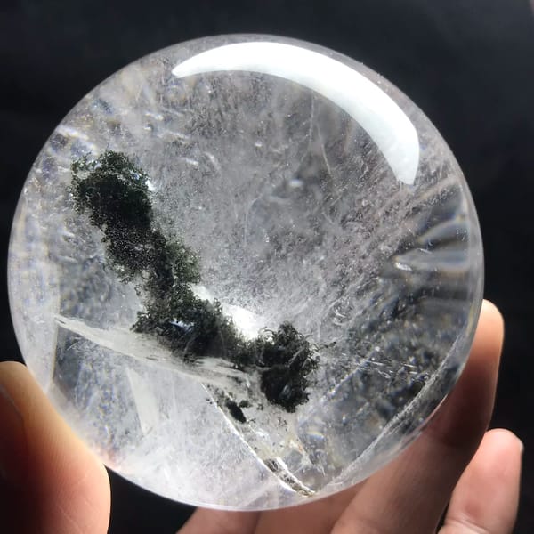 Curving green phantom and white mica blade in the clear quartz