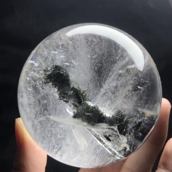 Mossy green inclusion stretching across the lower sphere