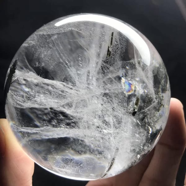 Dense white feathery veils with a small rainbow glint