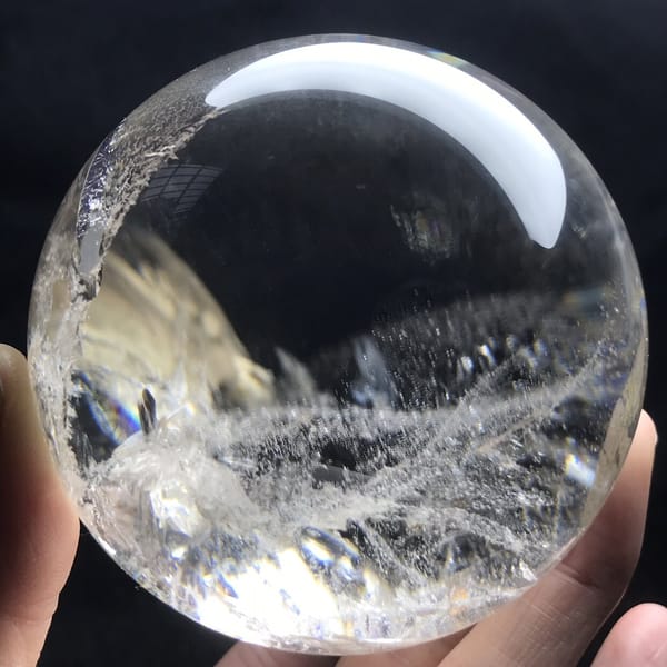 Long white cloud-like veil across the clear quartz sphere