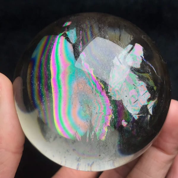 Tall rainbow band running vertically through the clear sphere