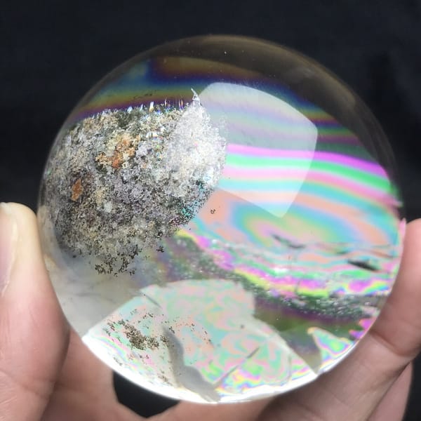 Grey garden cluster with orange specks and a rainbow below