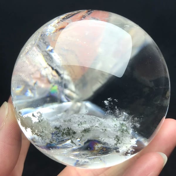 Flat white phantom plane with green flecks across clear quartz